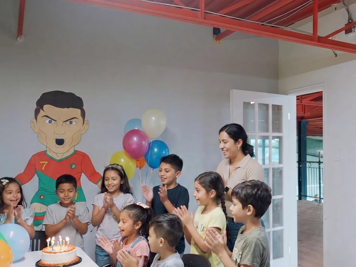 Enfants célébrant un anniversaire avec un gâteau dans la salle de fête FootVibe
